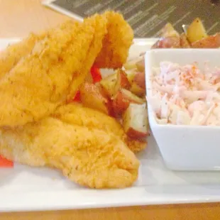 a plate of food with breaded fish and coleslaw