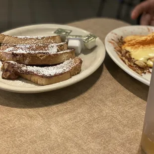 a plate of french toast and a glass of orange juice
