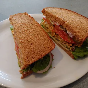 Curry Chicken Sandwich (with onions, lettuce, tomato, pickles, dijon mustard, wheat bread).