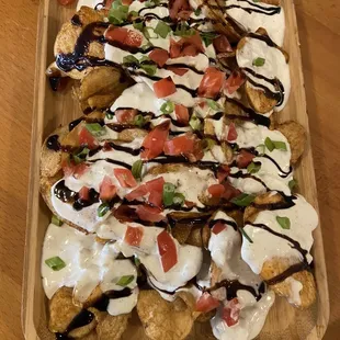 Pub Chips $6.00 hot, crispy chips with fresh creamy gorgonzola, balsamic glaze and green onion.