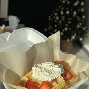 Belgian waffles topped with whipped cream and honey