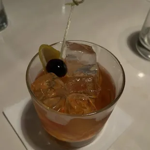 a drink with olives and ice cubes