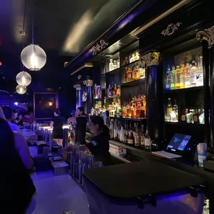 a bar with people sitting at the bar