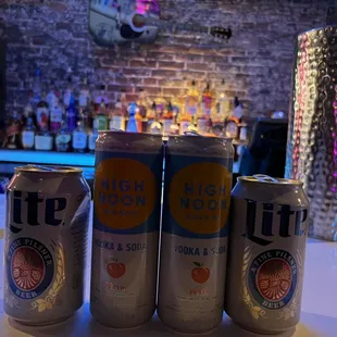 three cans of beer on a bar counter