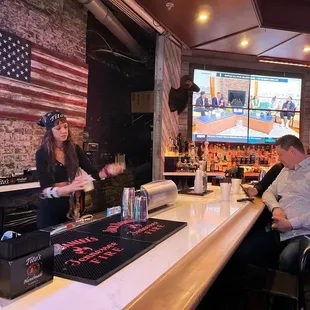 a couple of people sitting at a bar