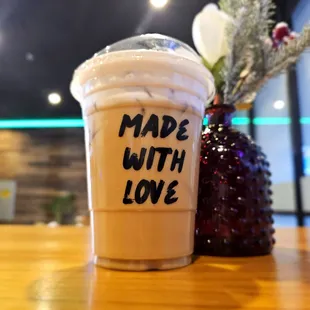 a cup of iced coffee with the words made with love written on it