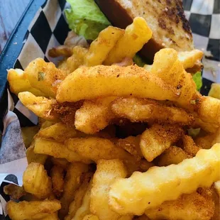 a basket of french fries and a sandwich
