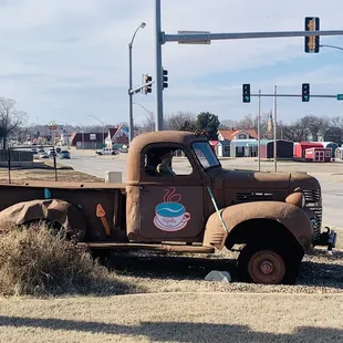 an old truck parked on the side of the road