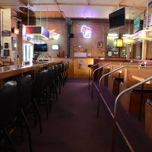 a row of bar stools and tables