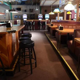 a row of bar stools and tables