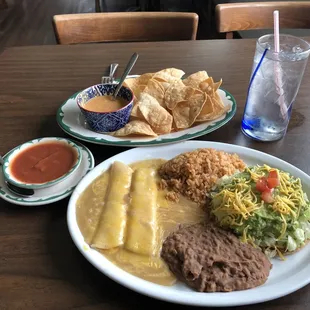 2 cheese enchiladas, bean and cheese tostada with guacamole, rice, beans, salsa, queso and chips.