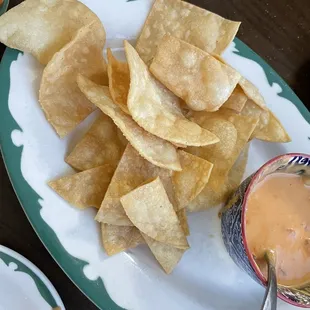 a plate of tortilla chips and salsa