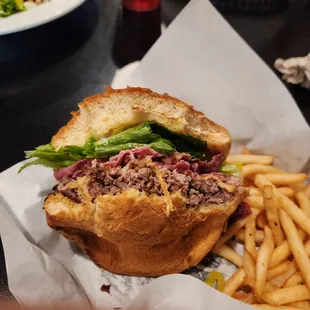 This is a pastrami burger, lean pastrami with provolone cheese. Big helping of fries.