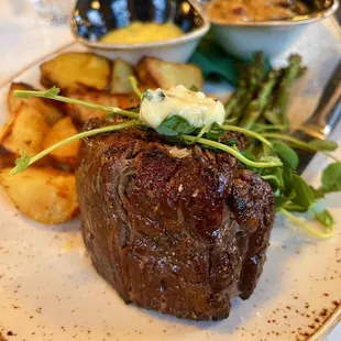 a plate of steak and potatoes