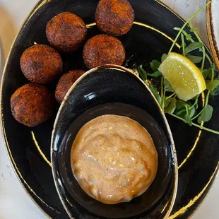 a plate of appetizers and dipping sauce