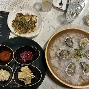 RAW OYSTERS ON HALF SHELL (red onion mignonette*horseradish*cocktail sauce*crackers) CAULIFLOWER CAPONATA (golden raisins*pine nuts*capers)