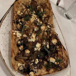 FIG FLATBREAD, Grilled flatbread, fig jam, carmelized onion, chevre cheese, fresh basil, balsamic glaze