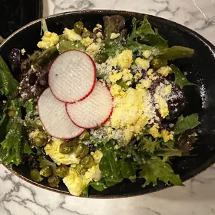 Vault signature salad (Field greens * dijon peppercorn vinaigrette * pecorino cheese * hard boiled egg * radish * green chickpeas)