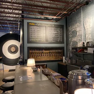 a bar with a large menu on the wall