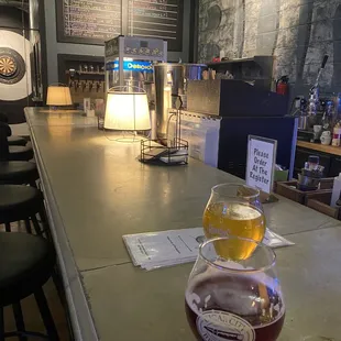 a glass of beer on a bar