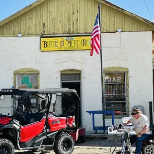 a man sitting on a motorcycle in front of a building