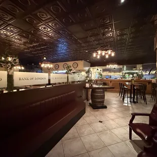 Booth seating is on the left of the partition, bar seating around the corner to the right. Love the ceilings and warm tones.