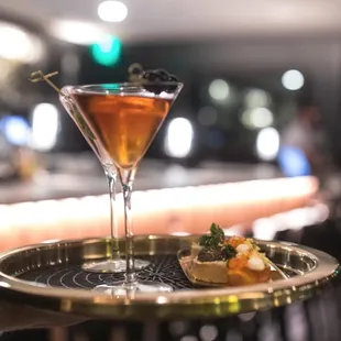a martini on a serving tray