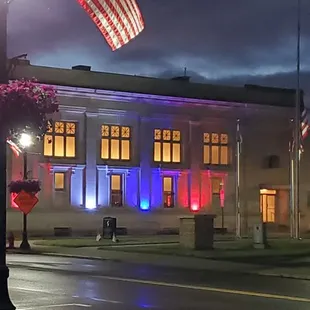 an american flag in front of a building