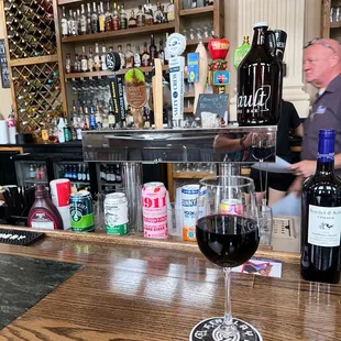 a glass of wine on the bar