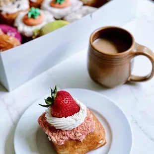 a box of doughnuts and a cup of coffee
