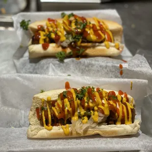 two hot dogs with ketchup and mustard