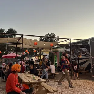 a group of people sitting at picnic tables