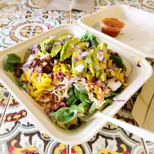 a salad in a styrofoam container