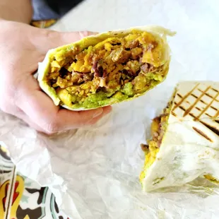 a person holding a burrito