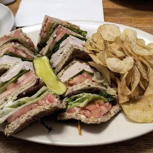 Turkey bacon club sandwich with kettle chips.