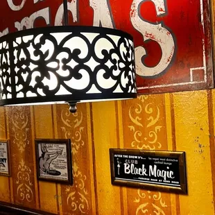 a wall of signs and a lamp