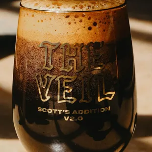 a glass of dark beer