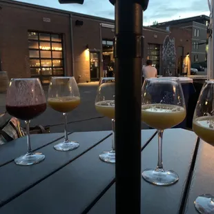 The Veil Memorial Day Weekend after sunset with the wine glasses and an umbrella table. Super chill.