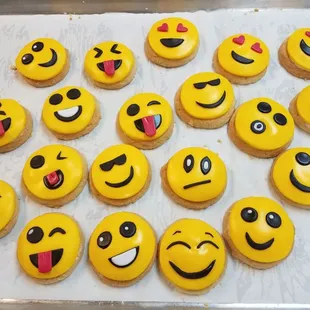 a tray of smiley face cupcakes