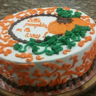 a birthday cake decorated with orange and green icing