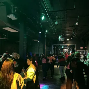 a crowd of people in a dimly lit room