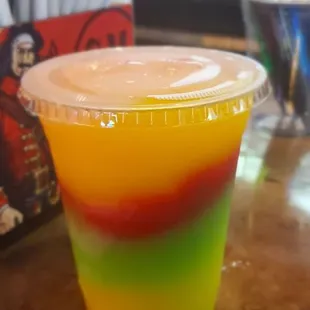 a colorful drink in a plastic cup
