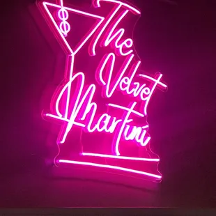 a neon sign that reads the velvet martini