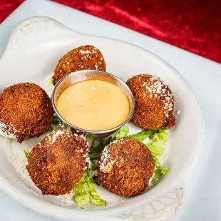 a plate of deep fried meatballs
