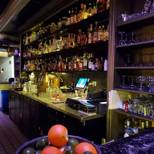 a bowl of fruit in front of a bar