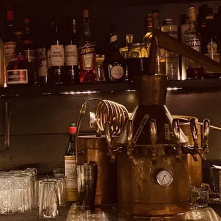 a bar with alcohol bottles and glasses