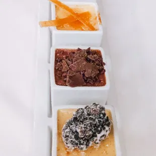 Trio of creme brulee flight. Chocolate, orange lemon and blackberry