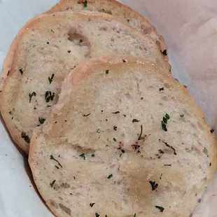 Buttery garlic bread - 2 baskets per table, additional are $5.95 (as of December 2023). Note - this basket is half empty!