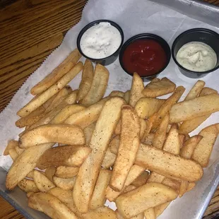 a tray of french fries and dips