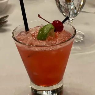 a cocktail with a cherry garnish